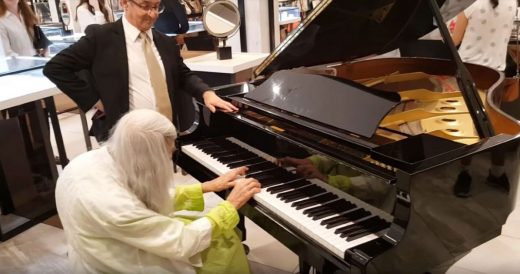 Elderly Woman Plays Piano In Department Store