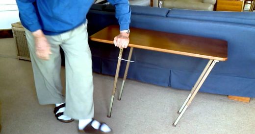 Man Steadies Wobbly Table By Turning It Clockwise