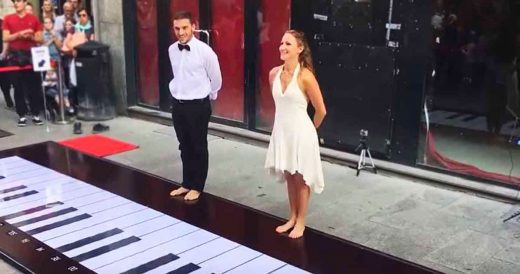 Couple Plays Classic Tune On Giant Piano With Their Feet