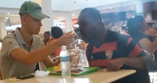 Kind Fast-Food Employee Feeds Meal To Man With Disability