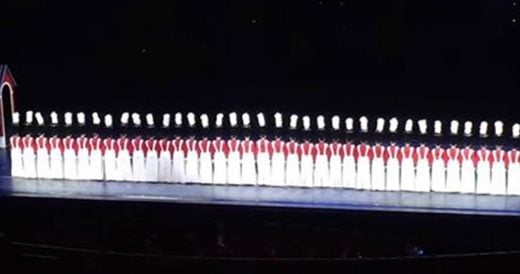 36 Women Dressed As Toy Soldiers “Fall” On Stage