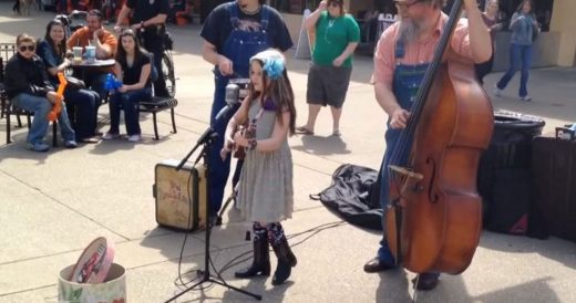 Girl Strums Ukulele and Sings. Passersby Stop When They Hear Her Voice.