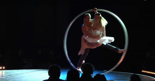 Woman And Man Gracefully Spin In Life-Sized Hoop