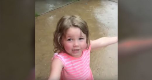 Little Girl Sings While Jumping In Rain Puddles