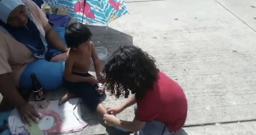 9-Year-Old Boy Spots Homeless Mom And Son, So He Starts Taking His Shoes Off