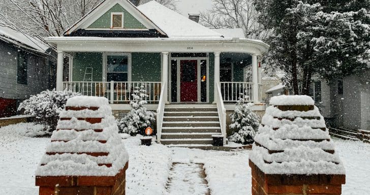 Man Removes Snow Off His Roof With A Hammer And A Rope