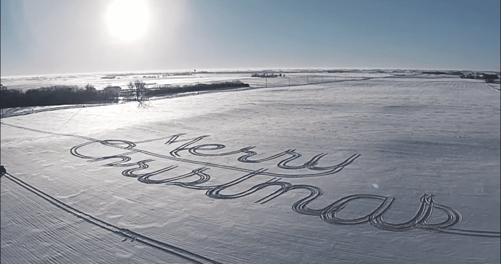 Farmer Makes Christmas Greeting Art Using A Tractor On A Snow-Covered Field