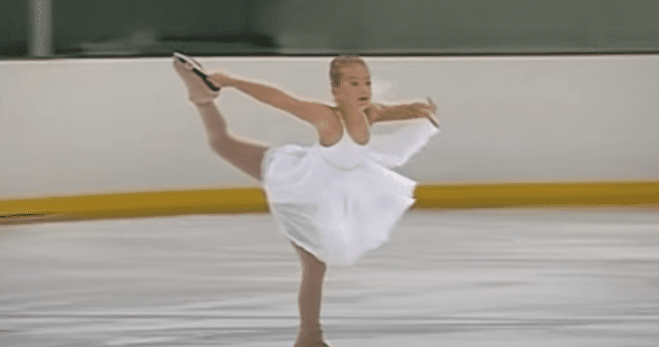 Graceful Little Girl Glides Across The Ice With Skating Routine