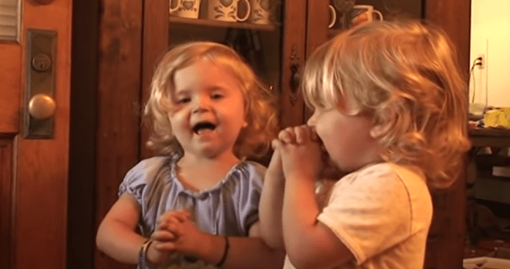 Sweet Twin Sisters Recite Prayer With Clasped Hands And Closed Eyes