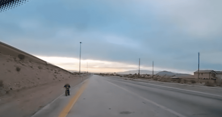 Couple Stops Traffic To Help Young Boy Biking Alone On Highway