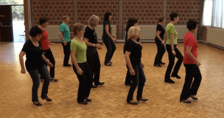 Group Of Seniors Do Line Dance To Chubby Checker Song